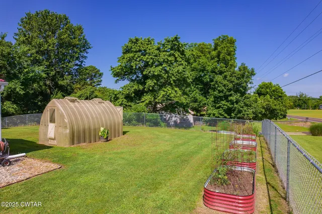 a backyard of a house with swimming pool and outdoor seating