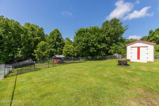 an aerial view of a residential houses with yard