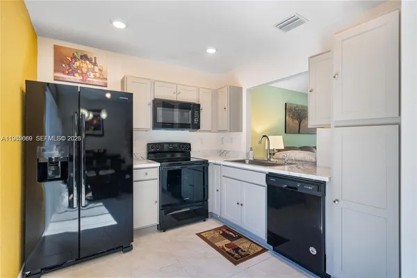 a view of a dining room with furniture and a flat screen tv