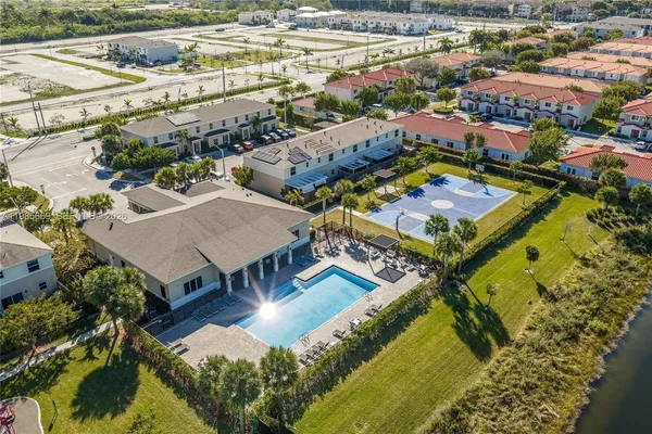 an aerial view of a residential houses with yard