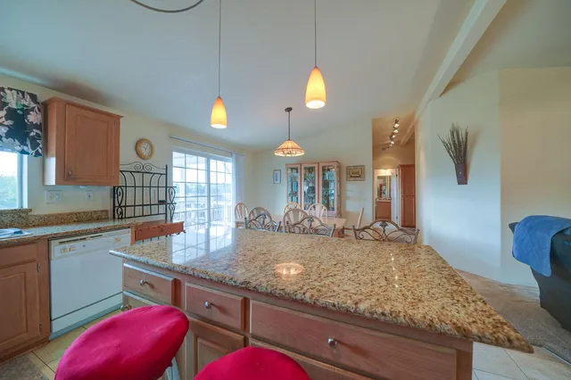 a kitchen with sink and view of living room