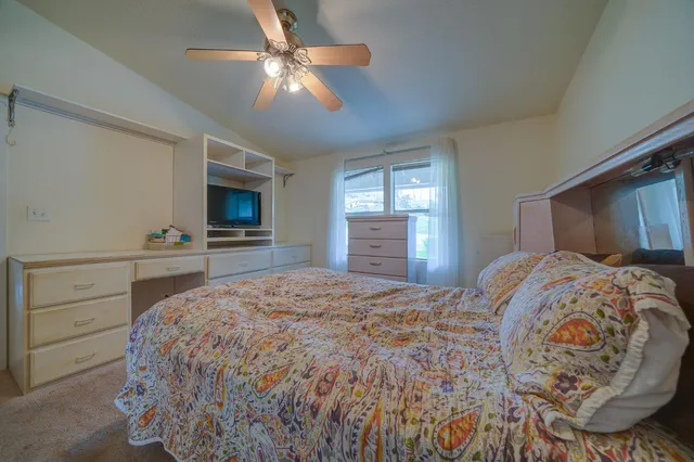 a bedroom with a large bed and a flat screen tv
