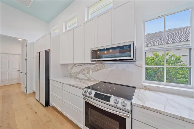 a view of a patio with chairs and potted plants
