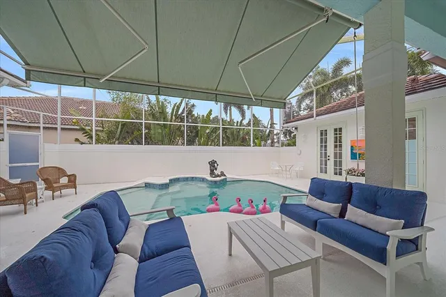an aerial view of residential houses with outdoor space and trees