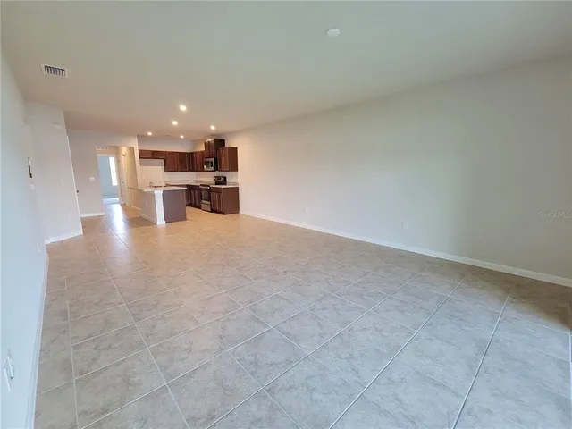 a kitchen with stainless steel appliances a refrigerator and a microwave