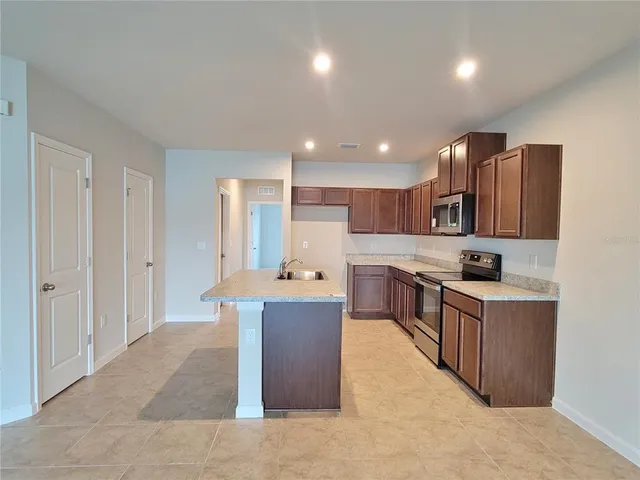 a kitchen with a sink and a microwave