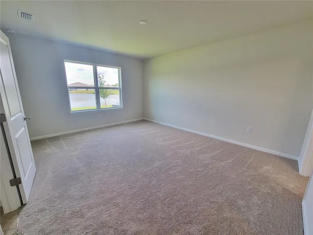 a view of an empty room and a window