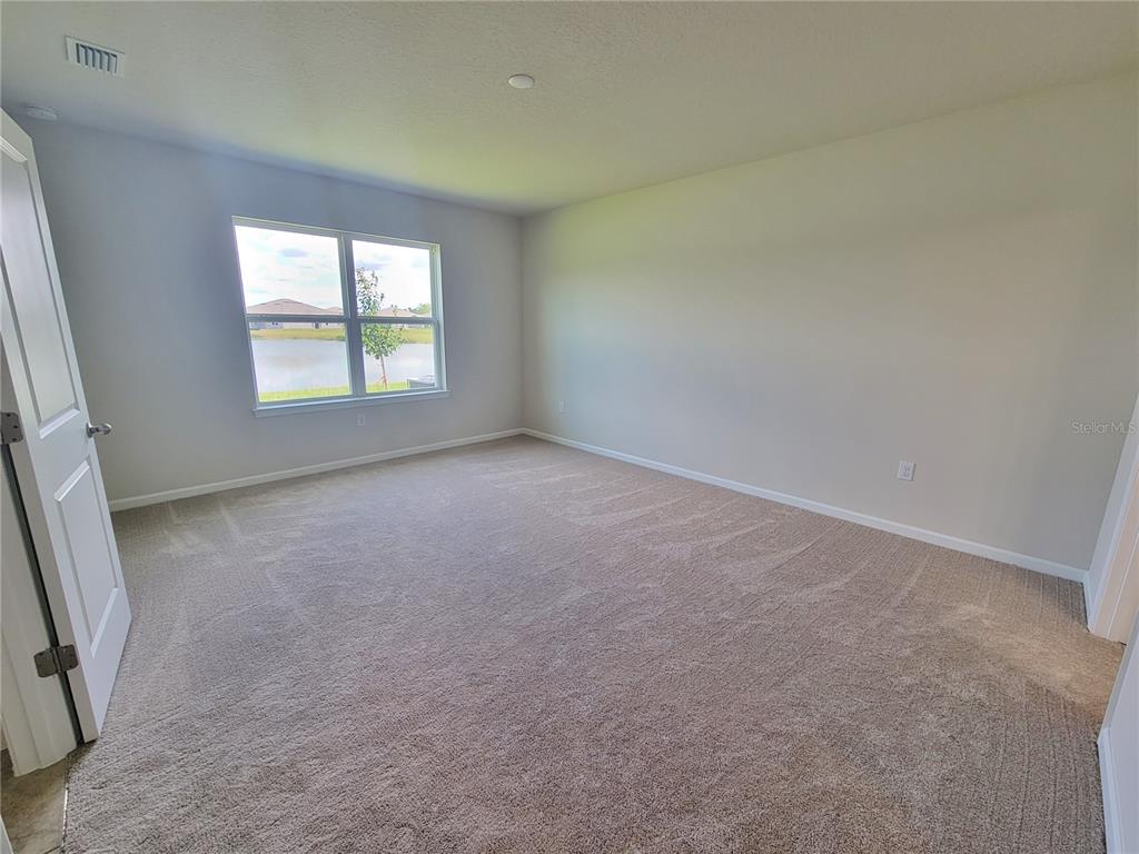 18008 Turning Leaf Circle Land O Lakes, FL 34638 - Photo 24 of 54 an empty room with windows