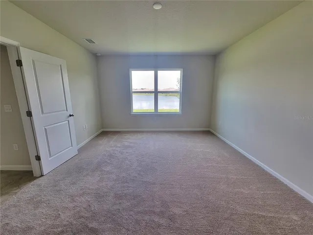 a view of an empty room and a window
