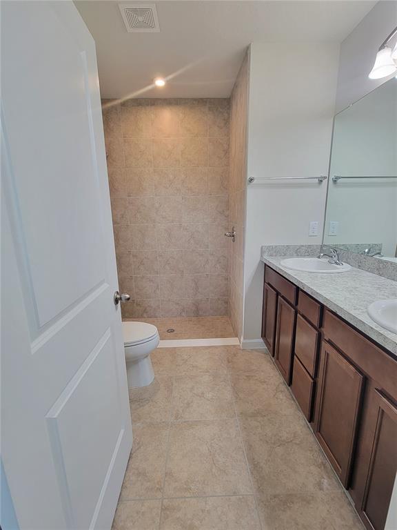 18008 Turning Leaf Circle Land O Lakes, FL 34638 - Photo 31 of 54 a bathroom with a granite countertop sink toilet and shower