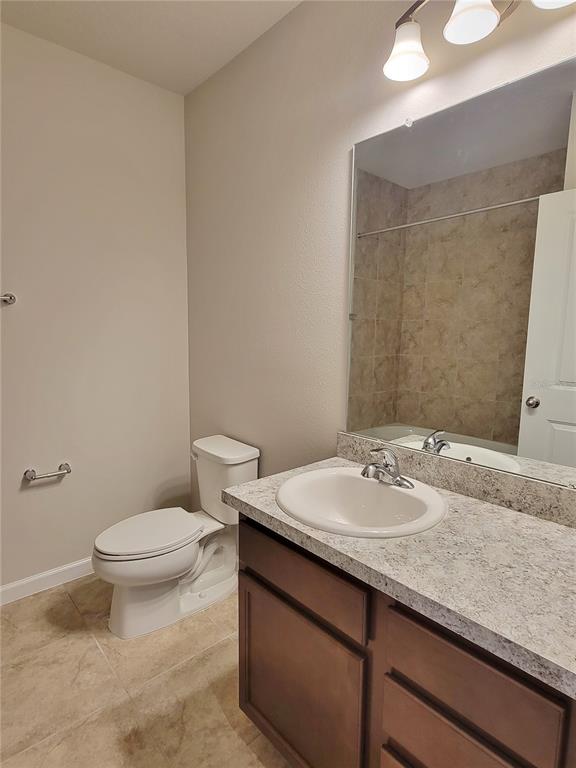 18008 Turning Leaf Circle Land O Lakes, FL 34638 - Photo 40 of 54 a bathroom with a granite countertop sink a toilet and a mirror