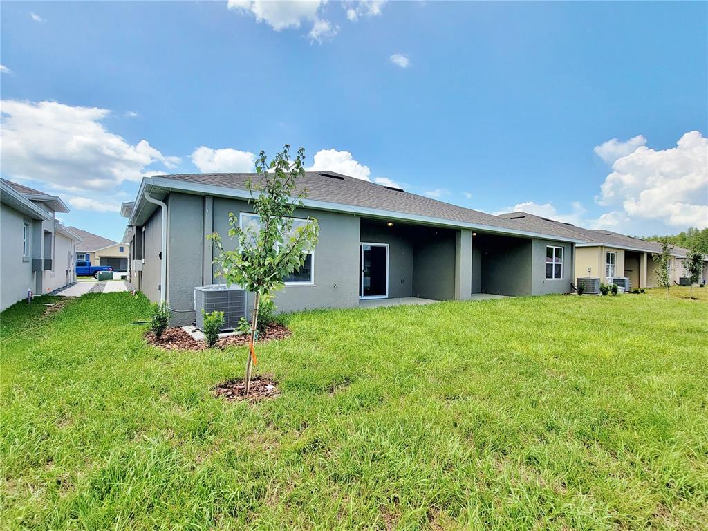 18008 Turning Leaf Circle Land O Lakes, FL 34638 - Photo 48 of 54 a front view of house with a garden and patio