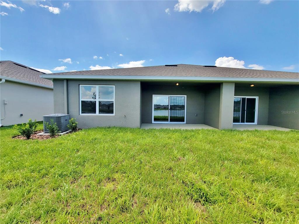 18008 Turning Leaf Circle Land O Lakes, FL 34638 - Photo 49 of 54 a view of a house with backyard and porch