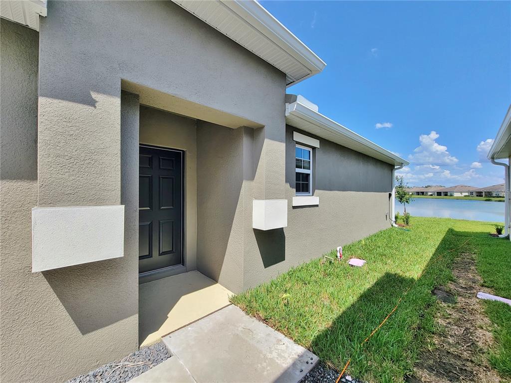 18008 Turning Leaf Circle Land O Lakes, FL 34638 - Photo 7 of 54 a front view of a house with garden