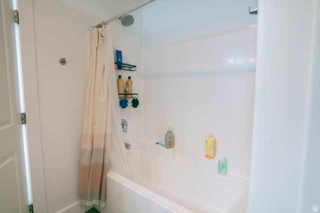 1486 West 2055th Street South Logan, UT 84339 - Photo 21 of 45 White acrylic tub and shower combination featuring a polished chrome showerhead and faucet