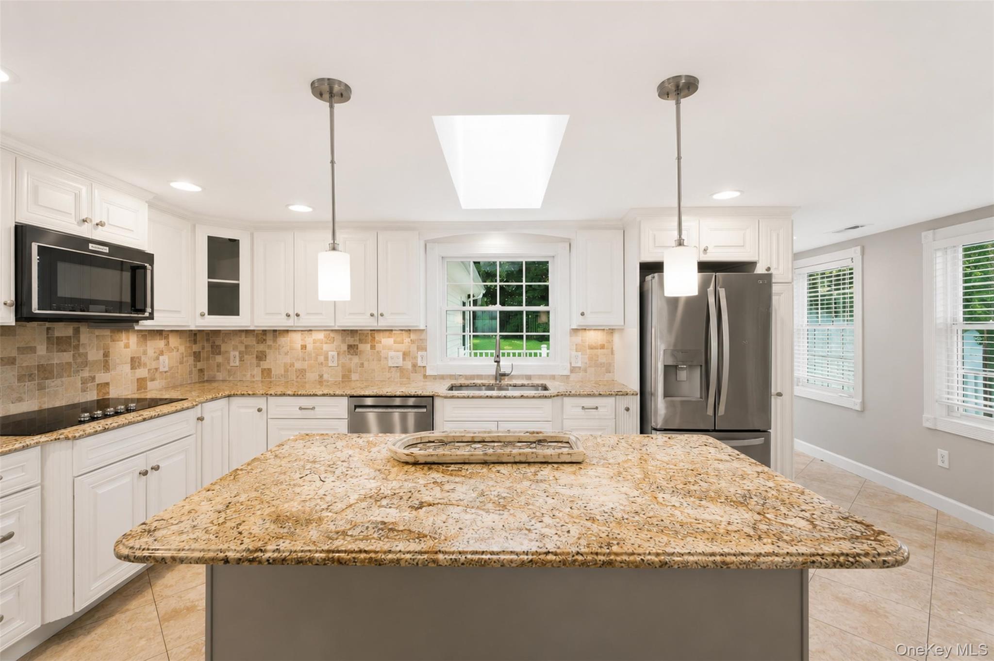 12 Leeside Road Carmel, NY 10512 - Photo 10 of 44 Kitchen featuring a central island with a stone countertop, white cabinetry, integrated stainless steel appliances, a tile backsplash, and recessed lighting