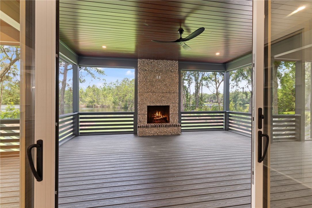 111 Stillwater Drive St. Simons Island, GA 31522 - Photo 35 of 51 large screened in porch off of living room with wood burning fireplace