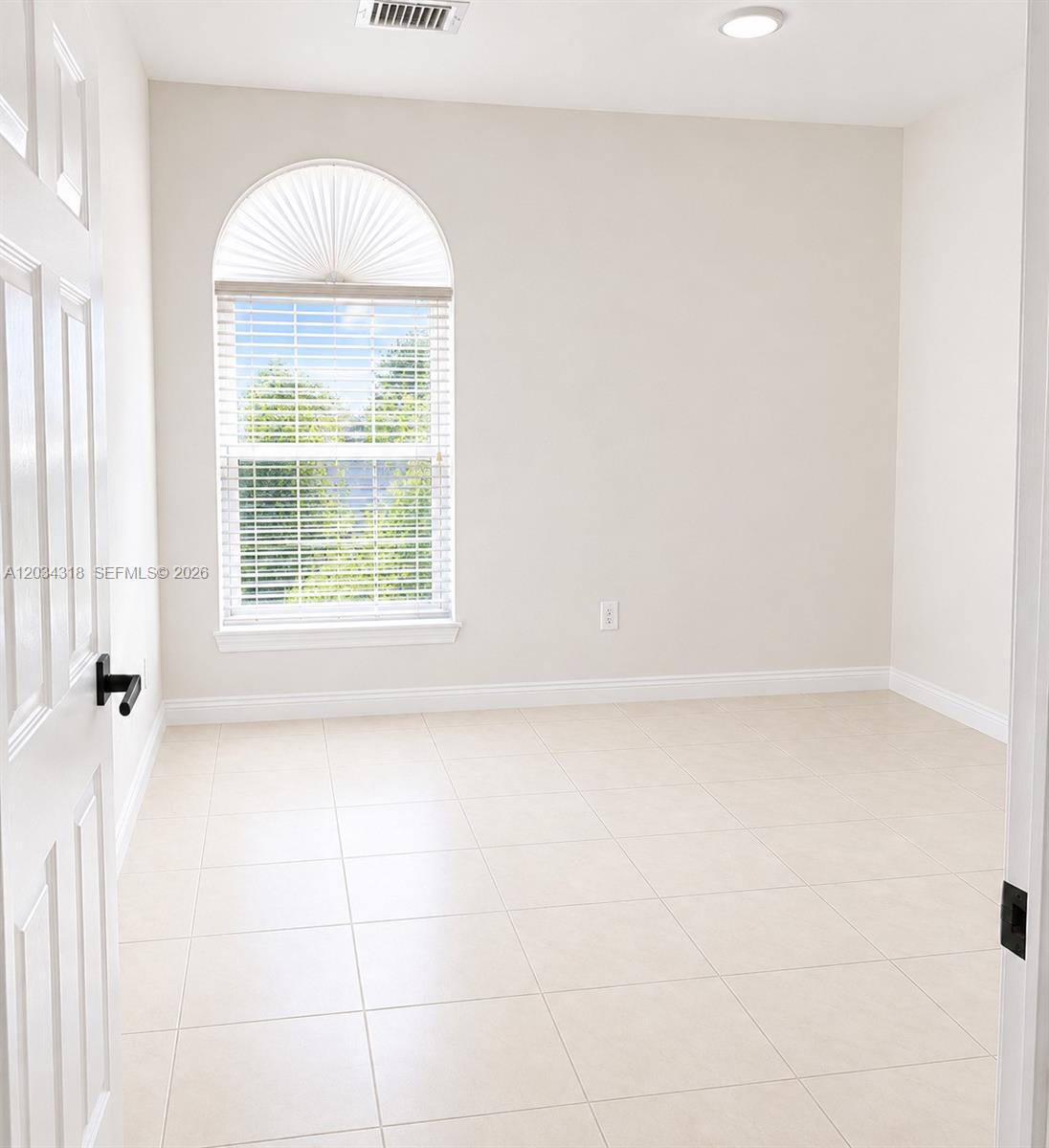 14856 Southwest 179th Street Miami, FL 33187 - Photo 25 of 33 a view of an empty room with a window