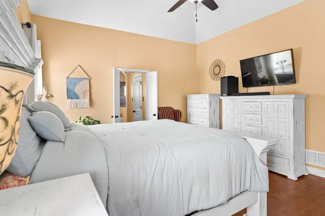 a bedroom with a large bed and a flat screen tv