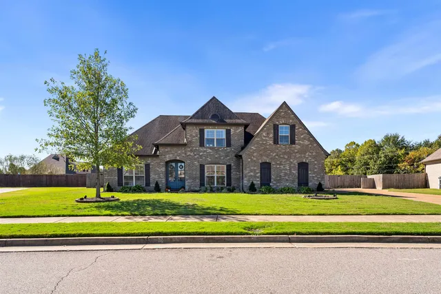 a front view of a house with a yard