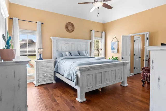 a bedroom with a large bed and a chandelier