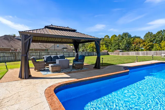 a view of a swimming pool with a patio