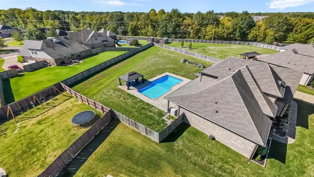 a view of a pool with a yard