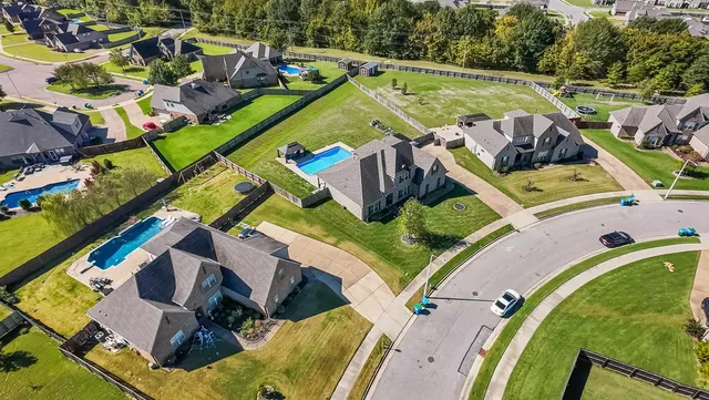 an aerial view of a house with outdoor space