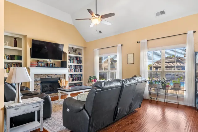 a living room with furniture a flat screen tv and a fireplace