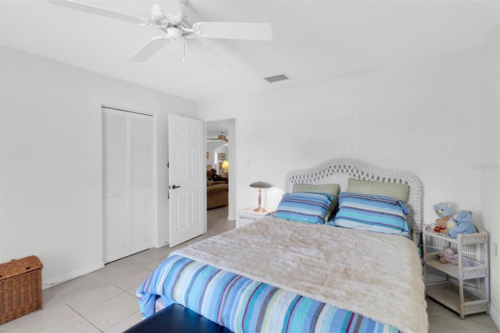 9052 Arundle Place New Port Richey, FL 34655 - Photo 19 of 57 a bedroom with a bed and a chandelier