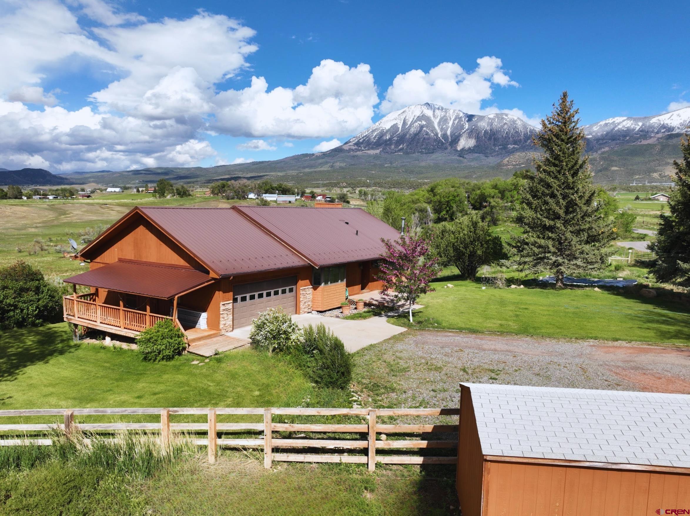 11253 Crawford Road Paonia, CO 81428 - Photo 1 of 44 an aerial view of a house with a garden and houses