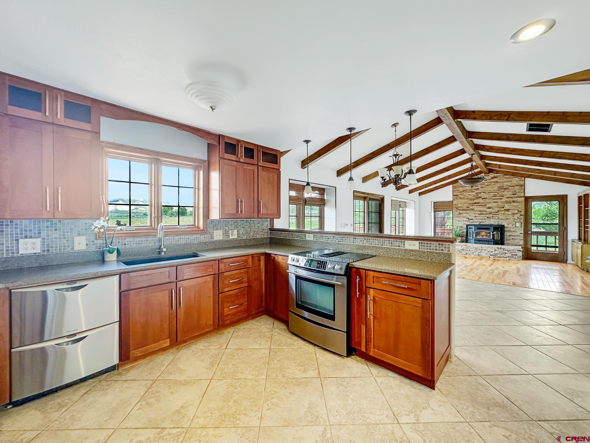 11253 Crawford Road Paonia, CO 81428 - Photo 12 of 44 a kitchen with stainless steel appliances granite countertop a stove sink and cabinets