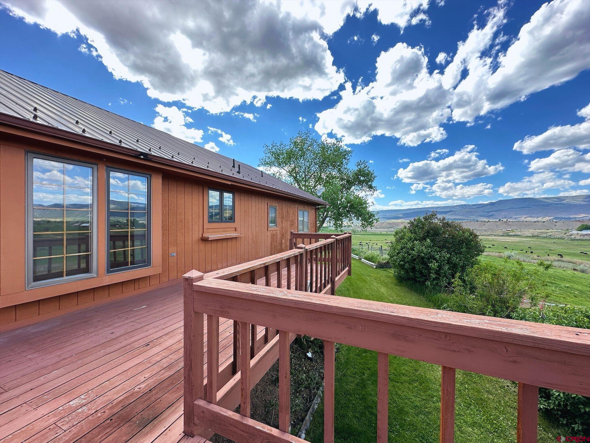 11253 Crawford Road Paonia, CO 81428 - Photo 32 of 44 a view of a roof deck with wooden floor and fence