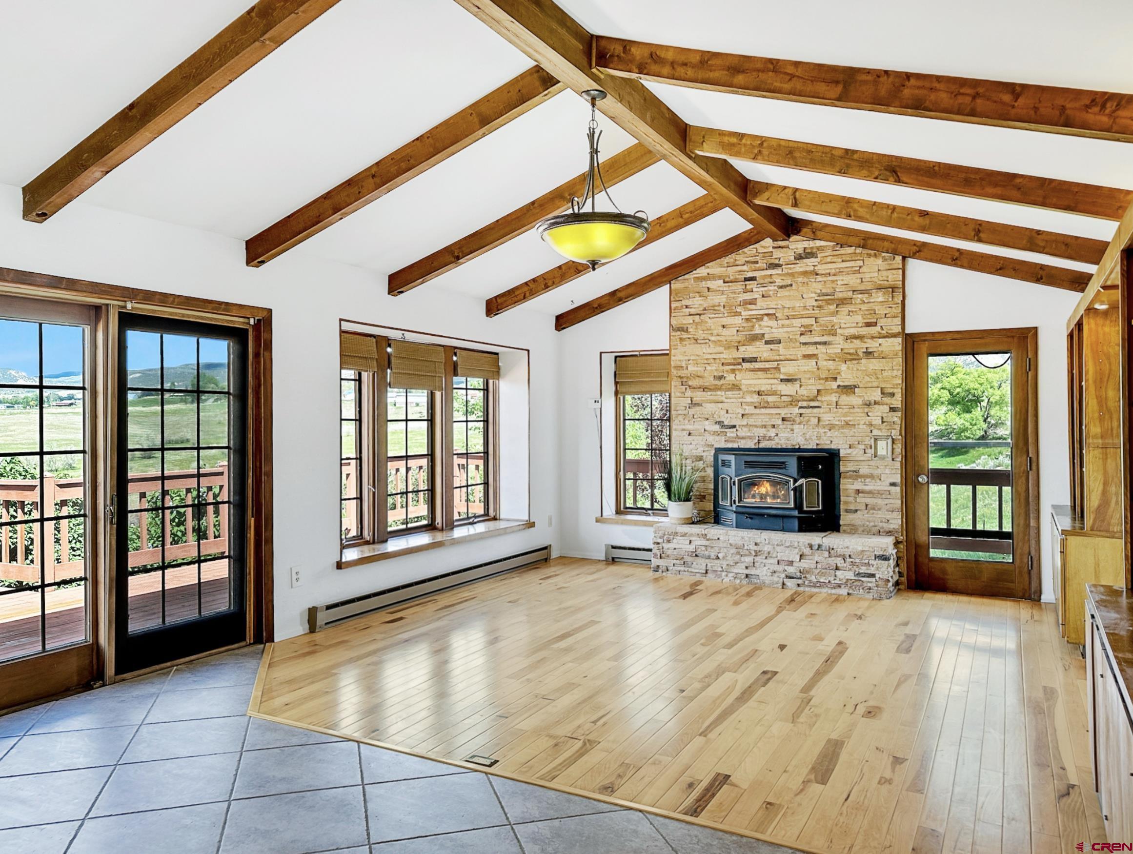 11253 Crawford Road Paonia, CO 81428 - Photo 9 of 44 a view of an empty room with a fireplace and a window