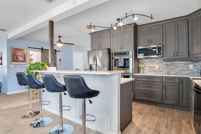 a kitchen with cabinets and stainless steel appliances