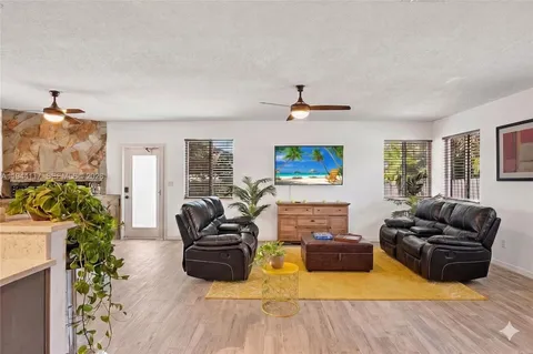a view of a patio with couches chairs and a umbrella