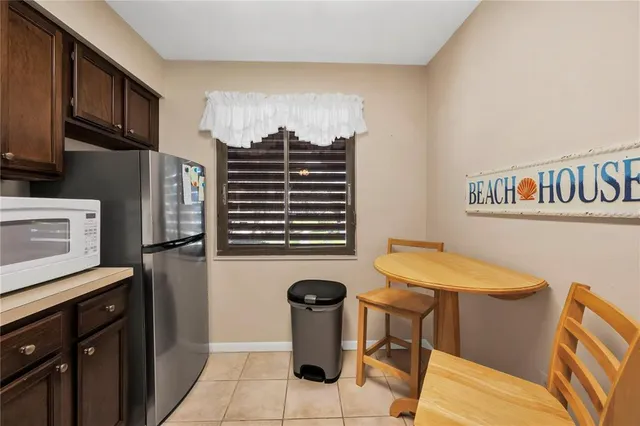 a kitchen with a refrigerator and a stove top oven