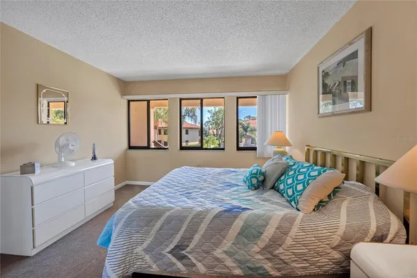 a bedroom with a large bed and a couch