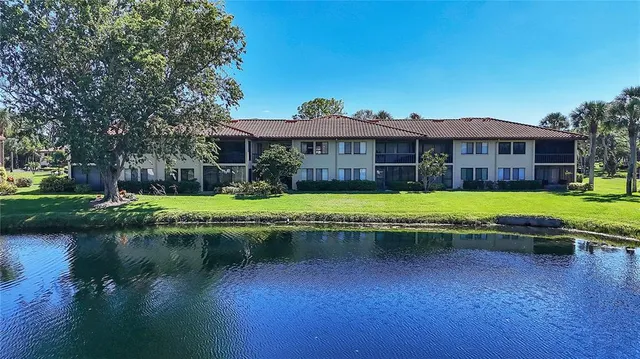 a view of a house with a yard table and chairs