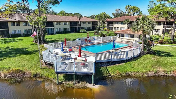 a aerial view of a house with swimming pool and a yard