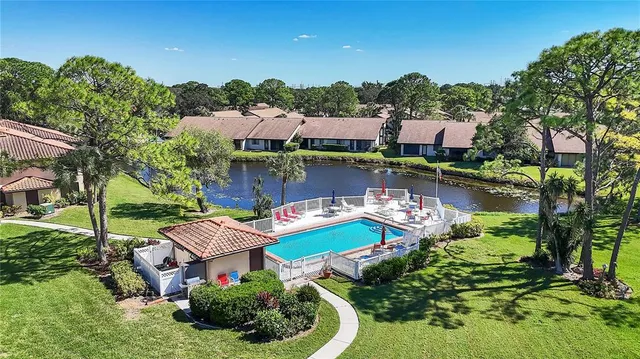 an aerial view of a house with swimming pool outdoor seating and yard