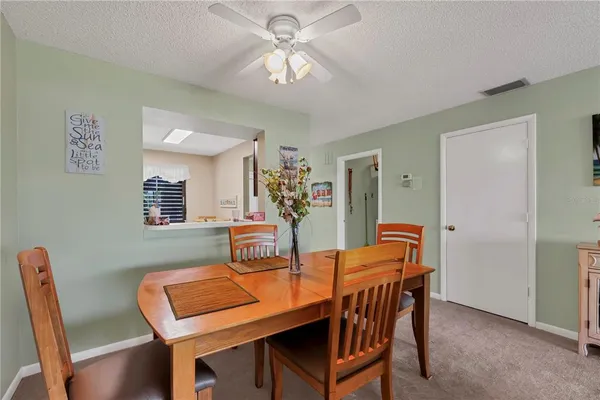 a dining room with furniture and chandelier