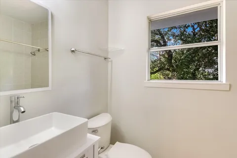 a white toilet sitting next to a bathroom sink