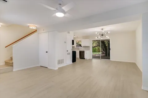 a view of a kitchen with a sink and a refrigerator