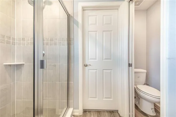 a bathroom with a toilet a sink and shower