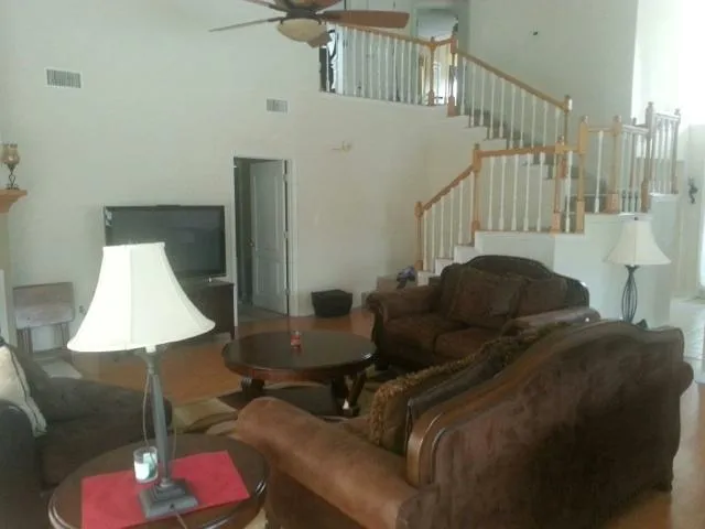 a living room with furniture and a lamp