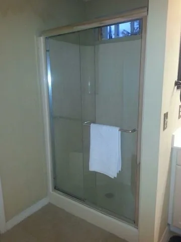 a bathroom with a glass shower door