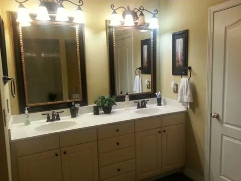 a bathroom with double vanity sinks and a mirror