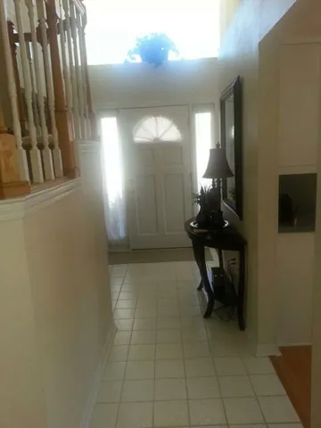 a view of a hallway with chairs and a potted plant