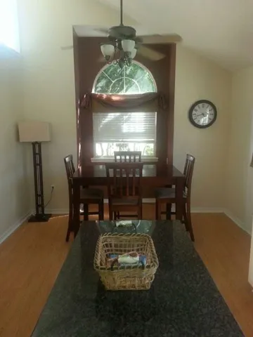 a dining room with furniture and window